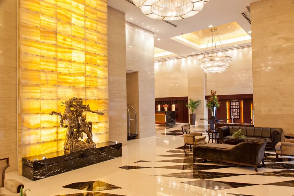 Joy-Nostalg Hotel lobby with illuminated stone feature wall